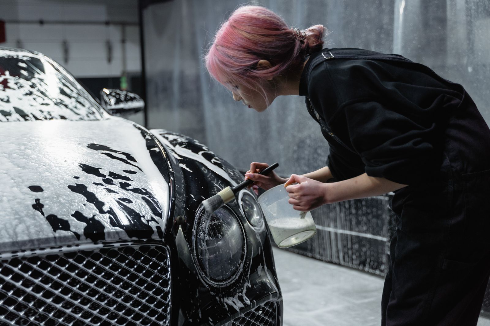 Attendant detailing a headlight
